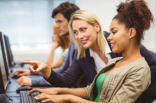 Teacher pointing to a student's computer screen
